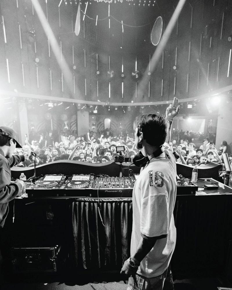 Crowd from behind the booth, black and white